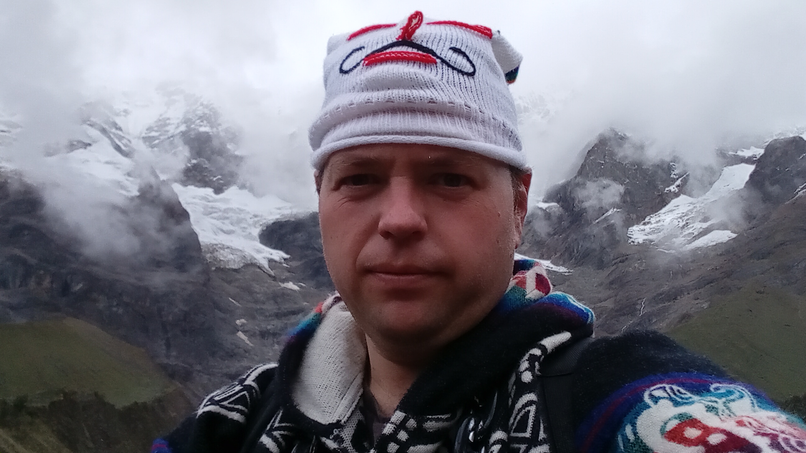 Ryan Deame standing in front of a glacial lake in Peru.